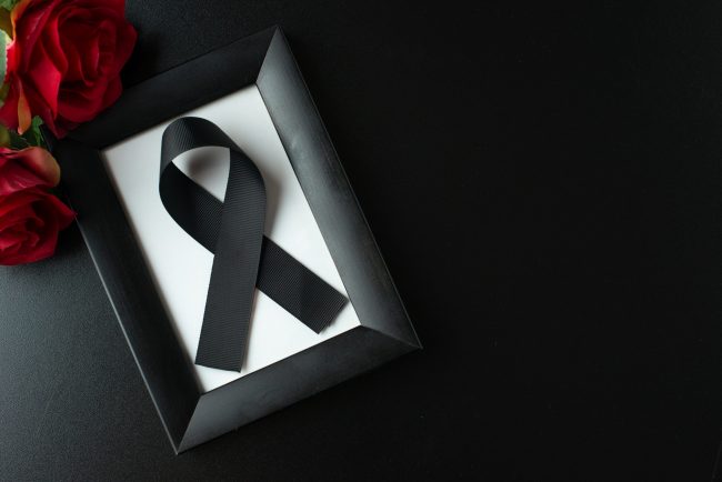 top-view-picture-frame-with-black-bow-dark-wall