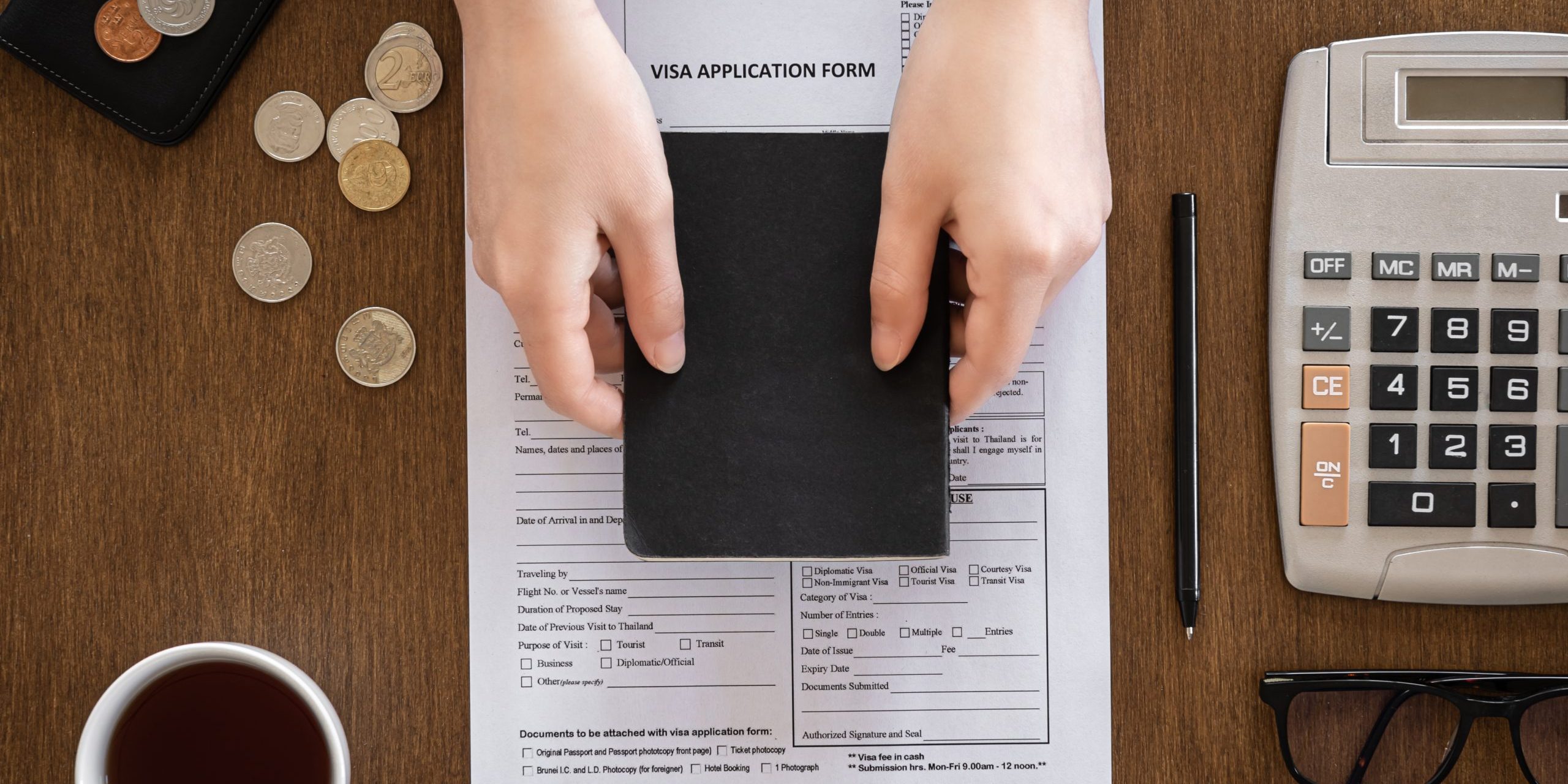 Visa application form on a wooden table, visa processing, registration, flat lay