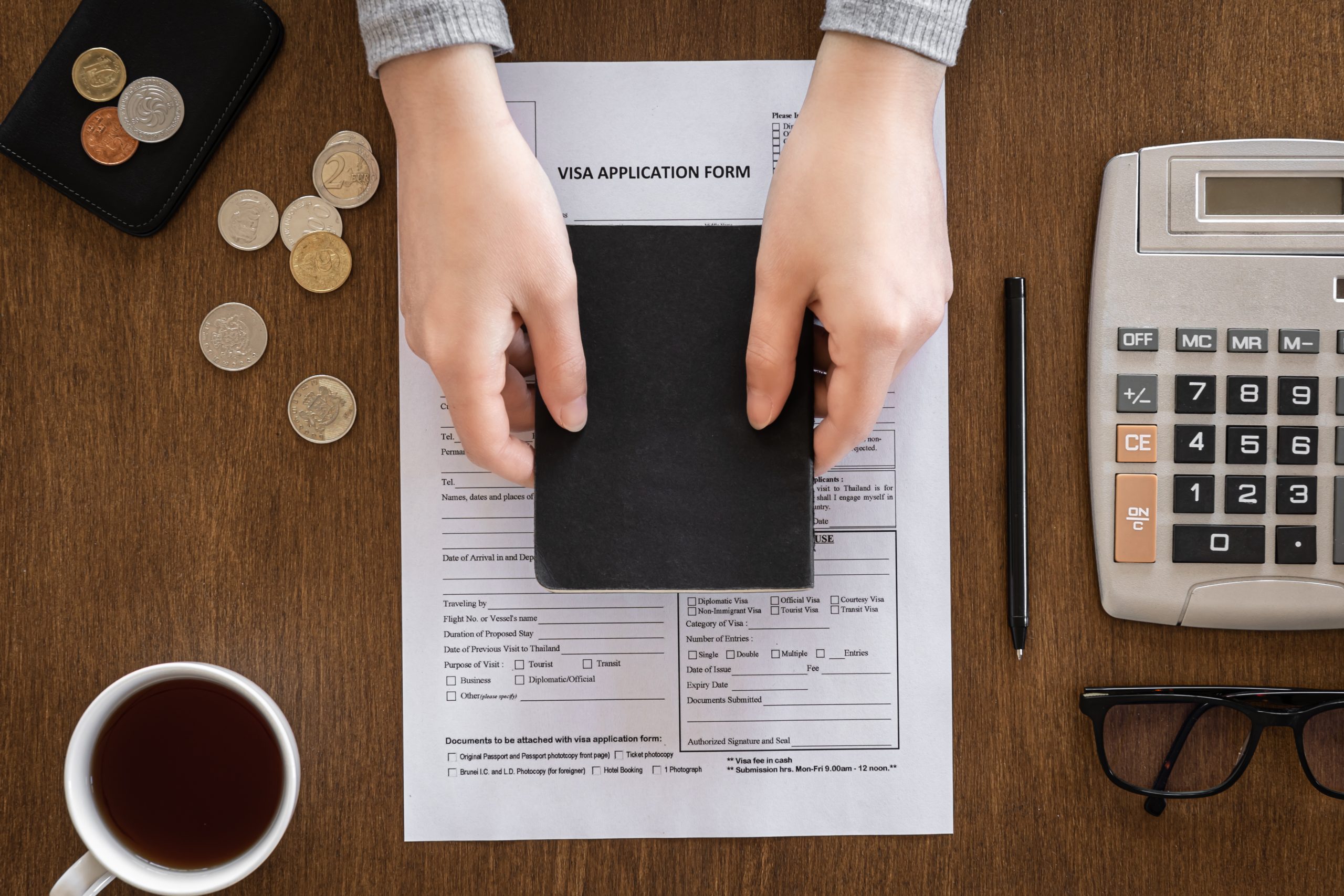 Visa application form on a wooden table, visa processing, registration, flat lay